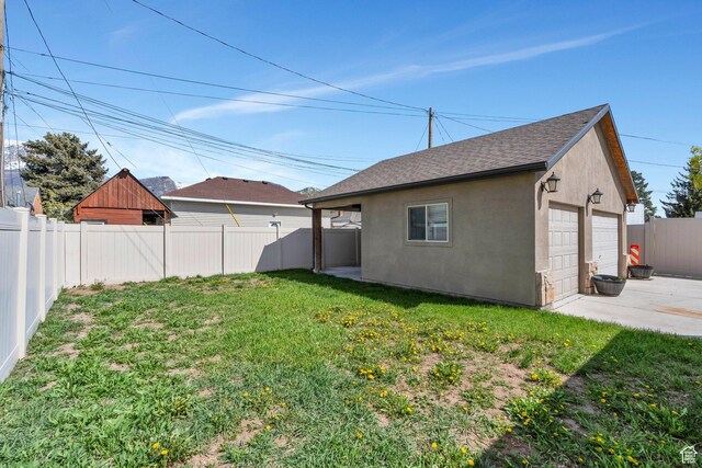 1001 S 400 E, Orem, UT 84097 - exterior space featuring a fenced backyard, a garage, a lawn, a shingled roof, and stucco siding