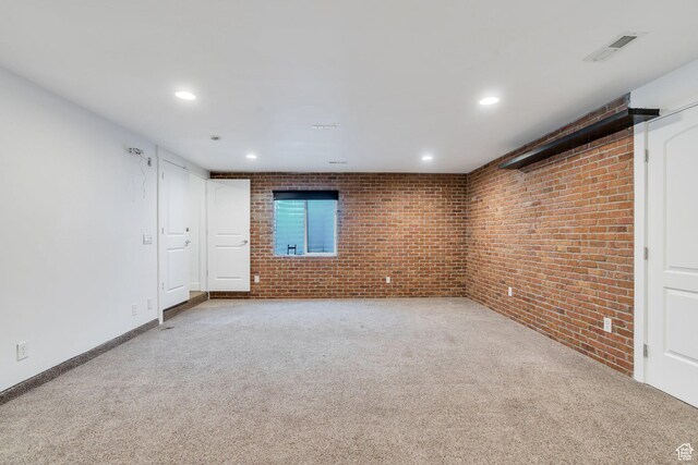 1001 S 400 E, Orem, UT 84097 - carpeted empty room with brick wall, visible vents, and recessed lighting