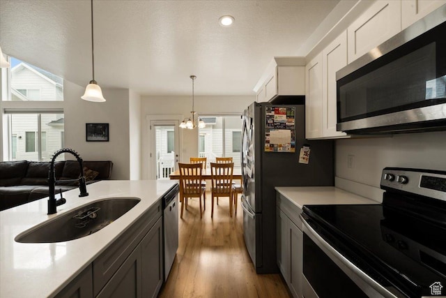 269 W 590 N, Vineyard, UT 84059 - kitchen featuring light countertops, a chandelier, appliances with stainless steel finishes, and a sink