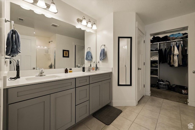 269 W 590 N, Vineyard, UT 84059 - bathroom featuring tile patterned floors, double vanity, visible vents, a sink, and a walk in closet