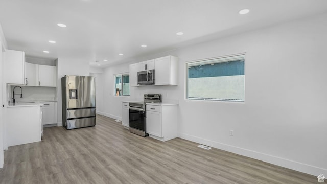 557 N 1200 W, Salt Lake City, UT 84116 - kitchen with baseboards, appliances with stainless steel finishes, a sink, and visible vents