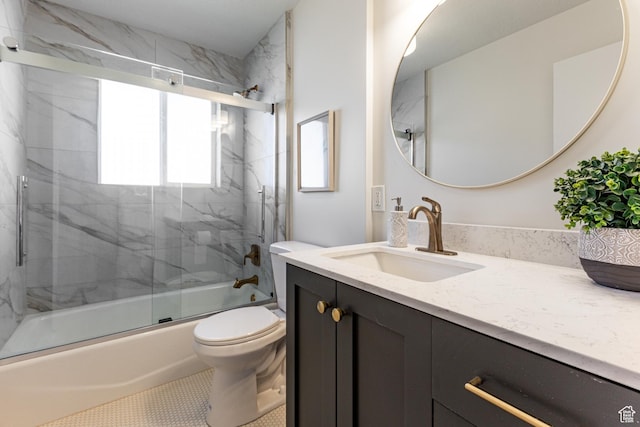 bathroom with shower / bath combination with glass door, toilet, and vanity
