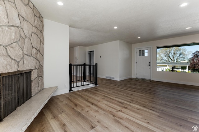 unfurnished living room featuring baseboards, wood finished floors, and recessed lighting