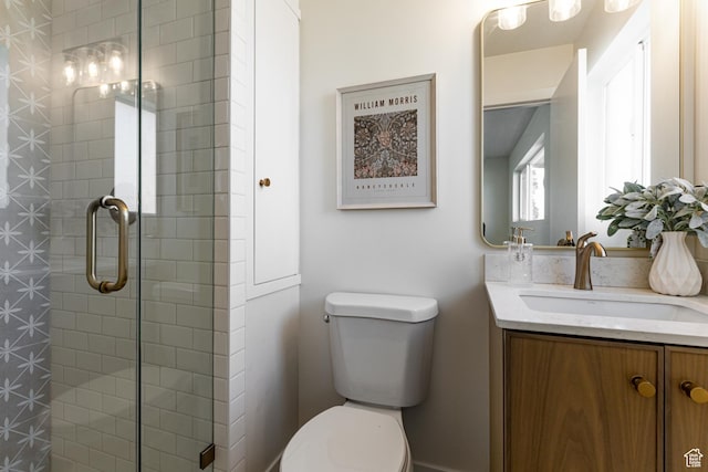 full bathroom featuring vanity, toilet, and a stall shower