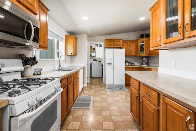 540 S 100 W, Manti, UT 84642 - kitchen featuring white appliances, a sink, washer / dryer, brown cabinets, and light countertops