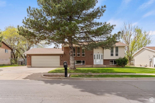1971 N 3060 W, Clinton, UT 84015 - bi-level home featuring an attached garage, brick siding, a front yard, and concrete driveway