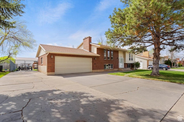 1971 N 3060 W, Clinton, UT 84015 - raised ranch with driveway, a chimney, fence, brick siding, and an attached garage