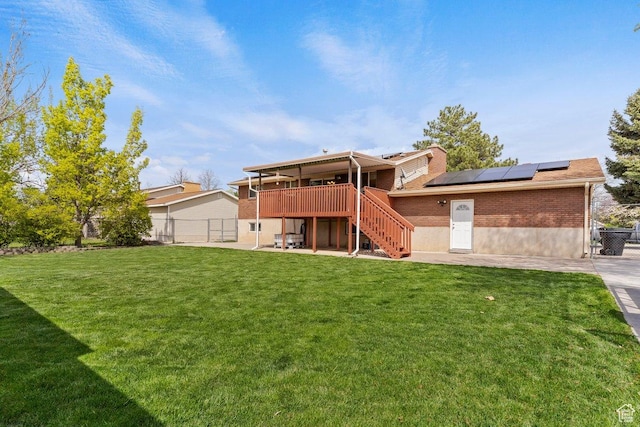 1971 N 3060 W, Clinton, UT 84015 - back of house with brick siding, a patio area, stairs, a yard, and roof mounted solar panels