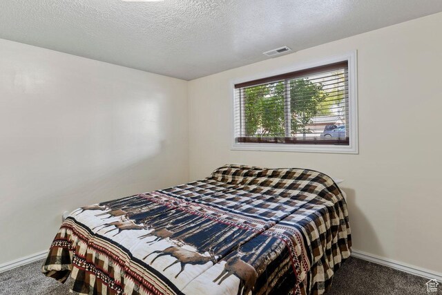 1971 N 3060 W, Clinton, UT 84015 - carpeted bedroom with a textured ceiling, visible vents, and baseboards