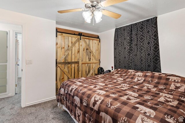 1971 N 3060 W, Clinton, UT 84015 - bedroom with a barn door, carpet floors, and a ceiling fan