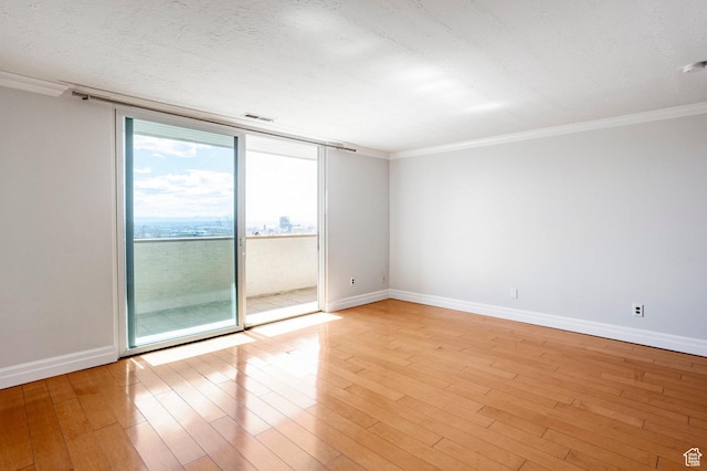 521 E 5th Ave Unit 302, Salt Lake City, UT 84103 - unfurnished room featuring light wood-style flooring, crown molding, and baseboards