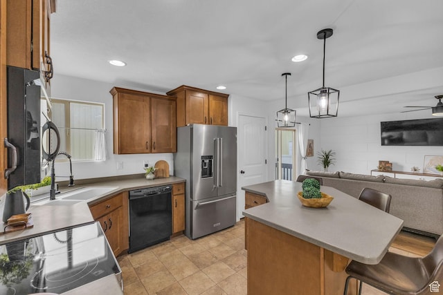 2526 S Andover St, West Haven, UT 84401 - kitchen with a sink, brown cabinets, open floor plan, appliances with stainless steel finishes, and recessed lighting