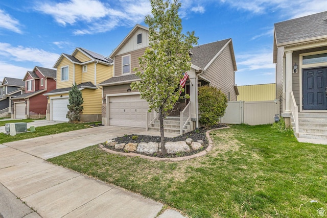 2526 S Andover St, West Haven, UT 84401 - view of front of home with a front lawn, driveway, board and batten siding, an attached garage, and fence