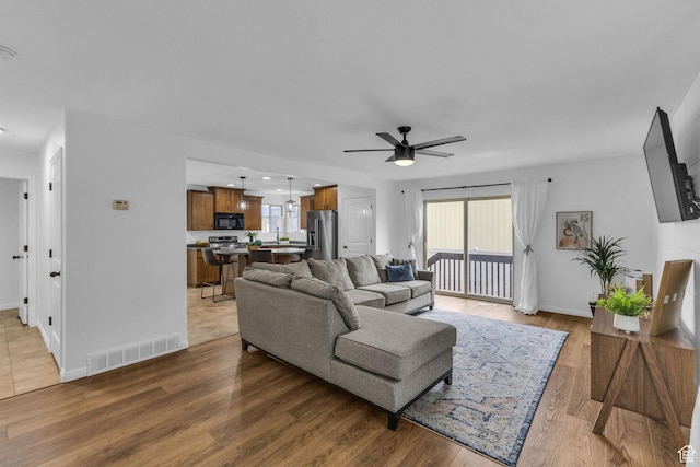 2526 S Andover St, West Haven, UT 84401 - living room featuring plenty of natural light, visible vents, baseboards, and ceiling fan