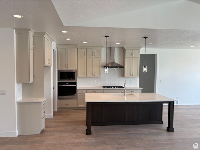 kitchen featuring recessed lighting, a sink, wall chimney exhaust hood, baseboards, and appliances with stainless steel finishes