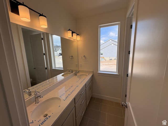 bathroom featuring a healthy amount of sunlight, toilet, and a sink