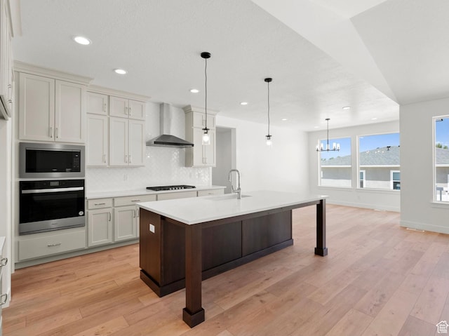 1256 W 800 S # 12, Spanish Fork, UT 84660 - kitchen featuring stainless steel oven, wall chimney range hood, built in microwave, decorative backsplash, and light countertops