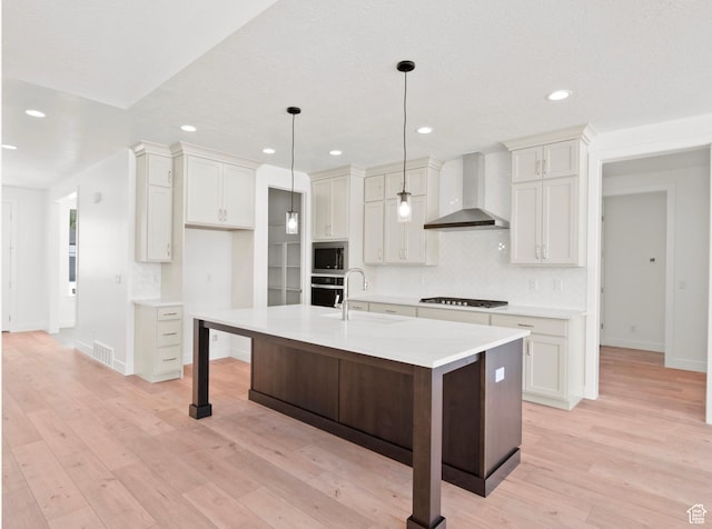 1256 W 800 S # 12, Spanish Fork, UT 84660 - kitchen with wall chimney range hood, stainless steel appliances, decorative backsplash, light wood finished floors, and recessed lighting