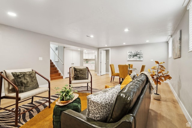 living area featuring stairway, light wood-style floors, and recessed lighting