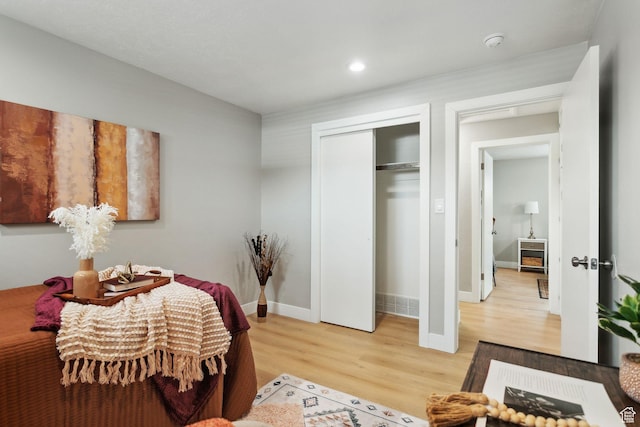 bedroom with baseboards, recessed lighting, a closet, and light wood finished floors