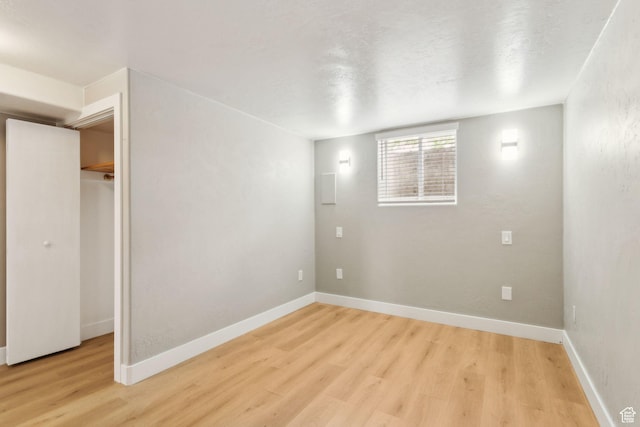 interior space with baseboards and light wood-type flooring