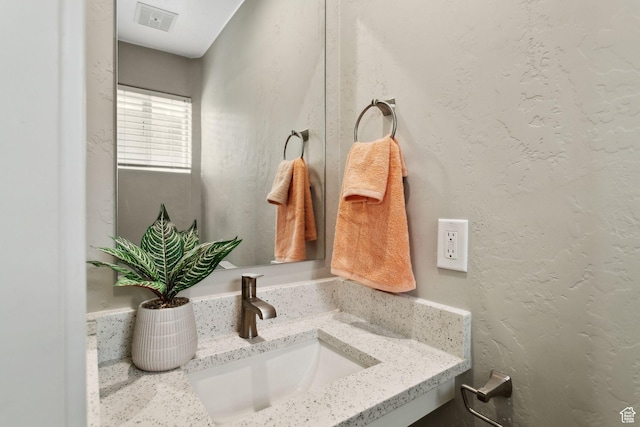 bathroom with vanity and visible vents