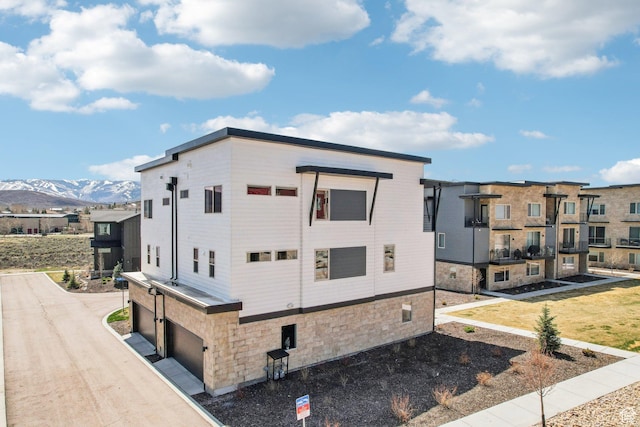 1152 Gambel Oak Way, Park City, UT 84098 - view of property exterior featuring an attached garage, stone siding, and a mountain view
