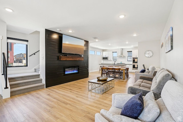 1152 Gambel Oak Way, Park City, UT 84098 - living area featuring recessed lighting, light wood-style flooring, stairs, and a large fireplace