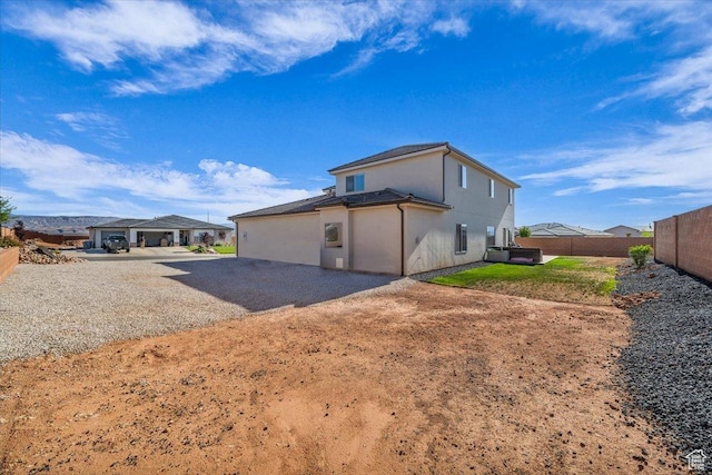 1519 E Honeycomb Dr S, St George, UT 84790 - back of house featuring stucco siding and gravel driveway