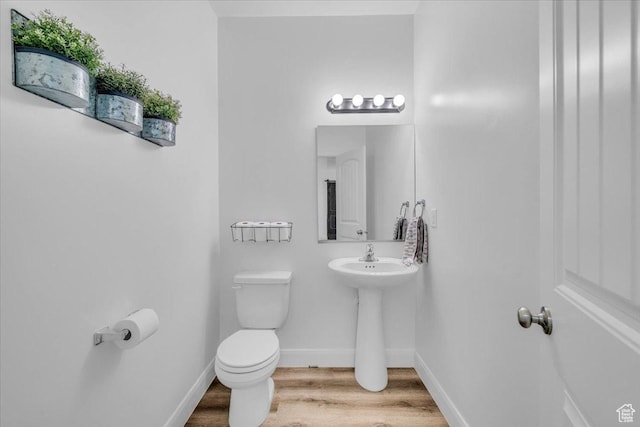1519 E Honeycomb Dr S, St George, UT 84790 - bathroom featuring toilet, wood finished floors, and baseboards