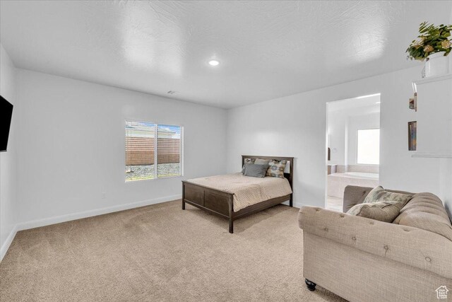 1519 E Honeycomb Dr S, St George, UT 84790 - bedroom with light carpet, baseboards, and ensuite bathroom