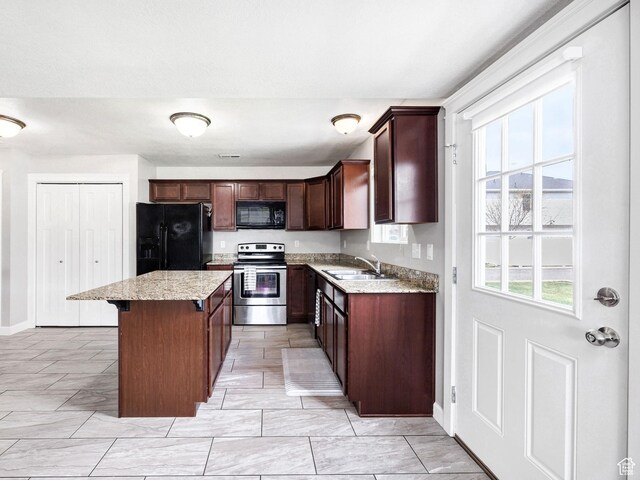 455 W 1140 N, Logan, UT 84341 - kitchen featuring a kitchen breakfast bar, a sink, a center island, baseboards, and black appliances