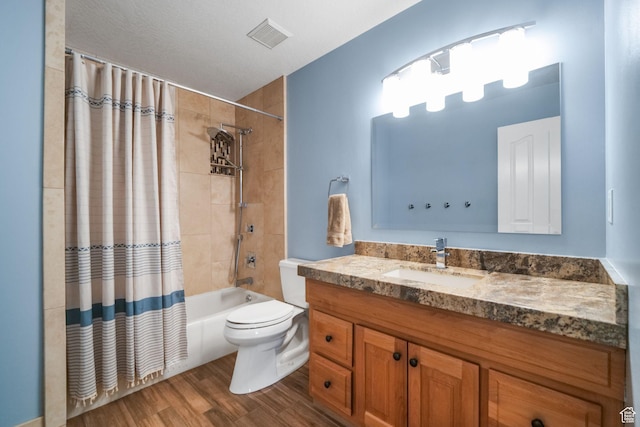 bathroom featuring toilet, vanity, wood finished floors, and shower / bath combo with shower curtain