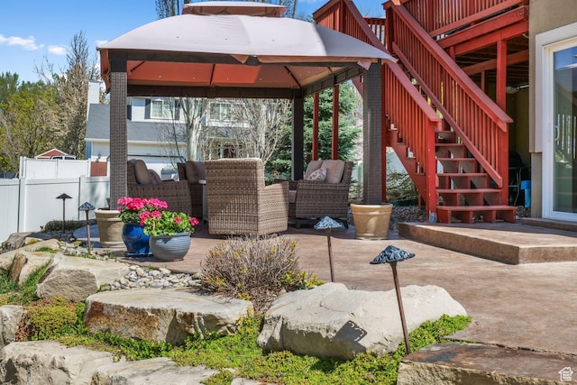 view of patio / terrace with a gazebo, outdoor lounge area, stairs, and fence