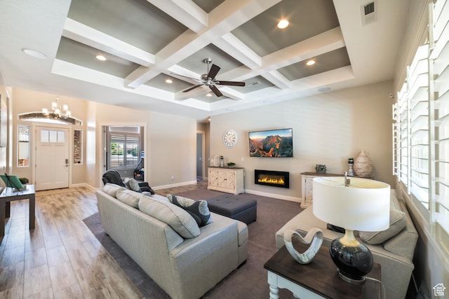living room with baseboards, a glass covered fireplace, beam ceiling, and coffered ceiling