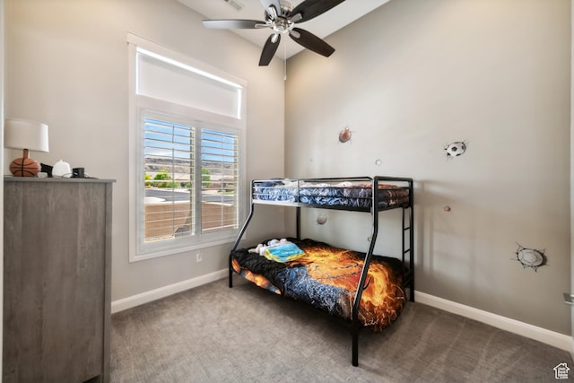 bedroom with vaulted ceiling, carpet, baseboards, and ceiling fan