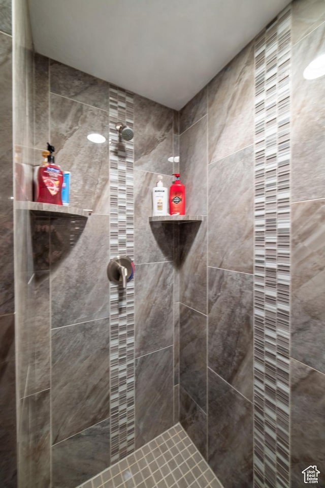 bathroom with a tile shower