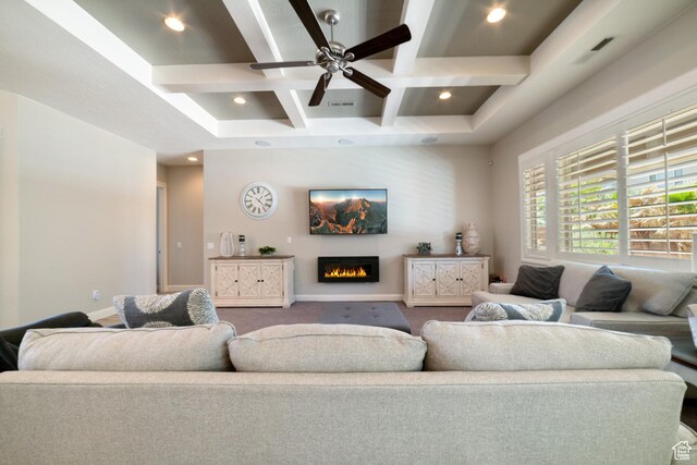 carpeted living room featuring recessed lighting, coffered ceiling, a warm lit fireplace, visible vents, and beamed ceiling