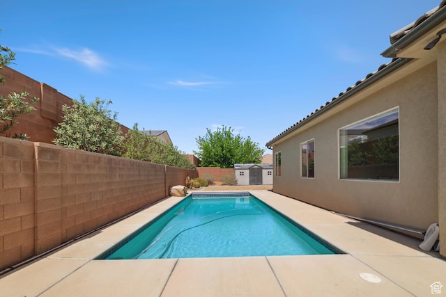 view of pool featuring a fenced in pool, a fenced backyard, a shed, an outdoor structure, and a patio