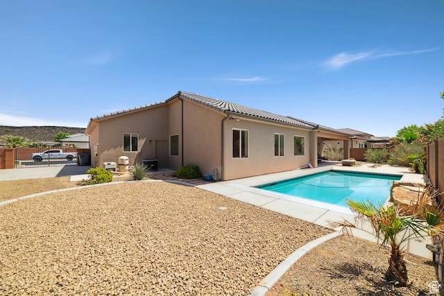 view of swimming pool featuring a fenced backyard, a gate, a patio, and a fenced in pool