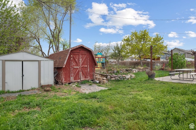 exterior space with an outdoor structure, fence, a patio area, and a shed