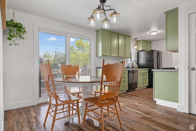 dining room with baseboards, a notable chandelier, and dark wood-type flooring
