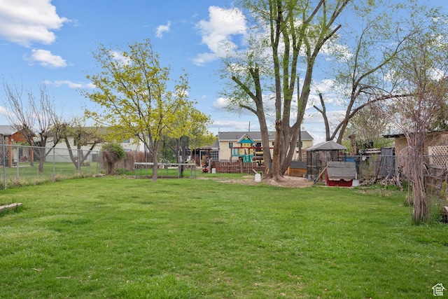 view of yard with a playground and fence