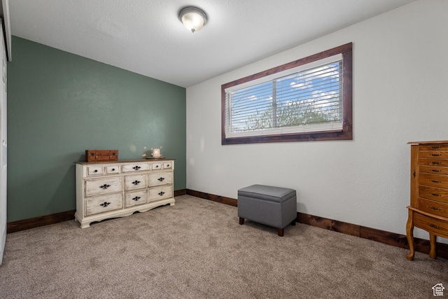 bedroom with baseboards and light colored carpet