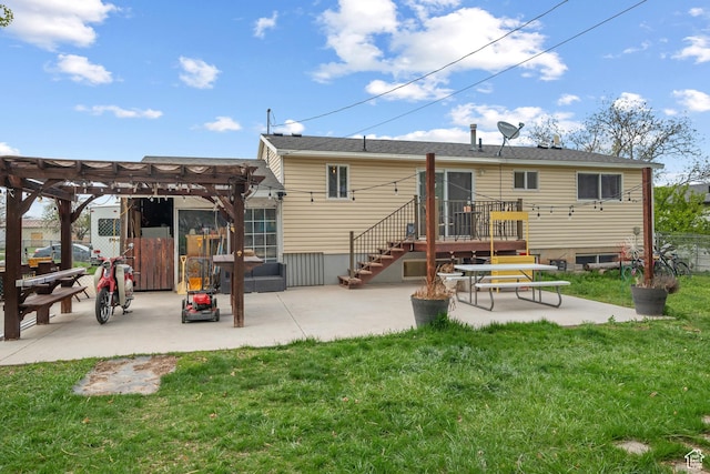 rear view of property with fence, a pergola, a yard, and a patio