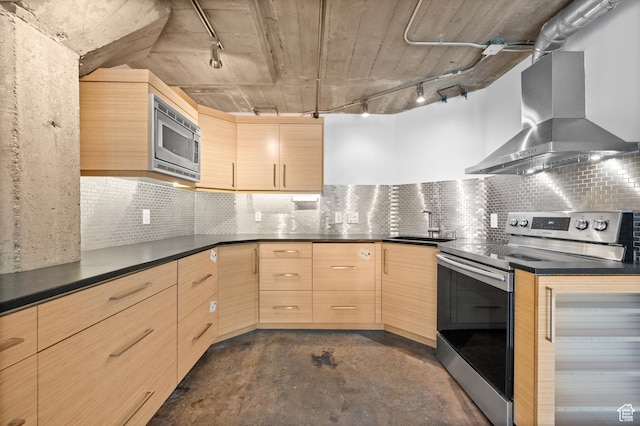 380 W 200 S Unit 104, Salt Lake City, UT 84101 - kitchen with light brown cabinets, wall chimney range hood, dark countertops, stainless steel appliances, and rail lighting