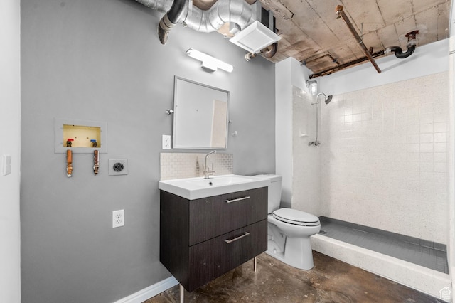380 W 200 S Unit 104, Salt Lake City, UT 84101 - bathroom featuring a tile shower, toilet, unfinished concrete flooring, vanity, and decorative backsplash