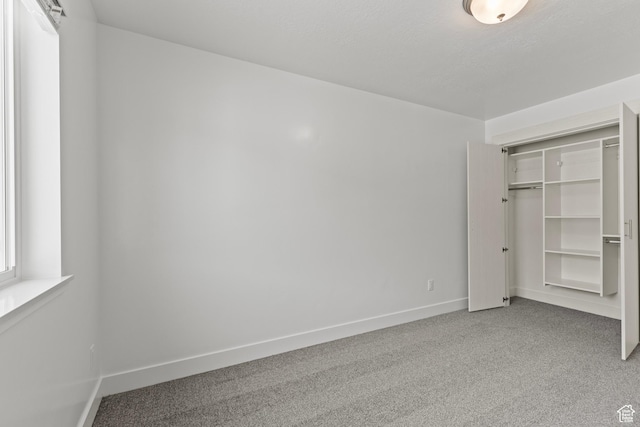 3374 S 1010 W, Nibley, UT 84321 - unfurnished bedroom featuring baseboards, carpet flooring, and a closet