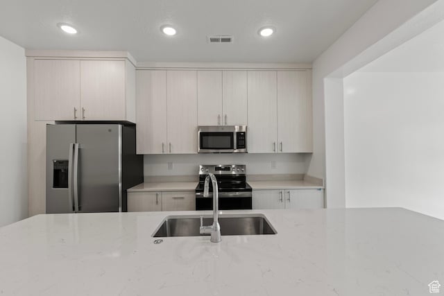 3374 S 1010 W, Nibley, UT 84321 - kitchen with recessed lighting, light stone countertops, stainless steel appliances, and a sink