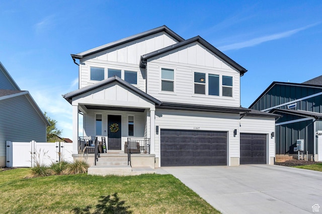 1167 S 1275 W, Clearfield, UT 84015 - view of front facade with driveway, board and batten siding, an attached garage, a porch, and a front yard